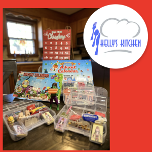 Red background with Kellys Kitchen Logo. An image to the left shows various advent calendars. Two are store bought and contain non-food items. One is homemade in clear multi-compartment container and includes items such as beef jerky, a Hulk action figure holding carrots, yogurt covered blueberries, puzzles, brain games, individually wrapped chocolates, and holiday theme erasers and stickers.