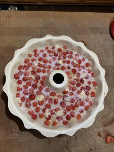 Photo from above of the uncooked vegan raspberry bundt cake prior to being put in the oven when all ingredients have been mixed together and added to the bundt pan.