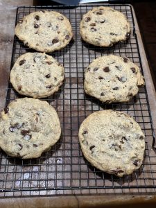 Photo of six cookies cooling on a baking rack.